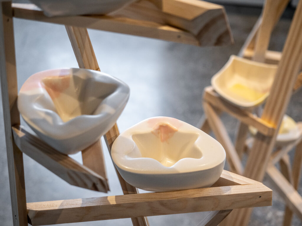 white bowl forms on wooden structure